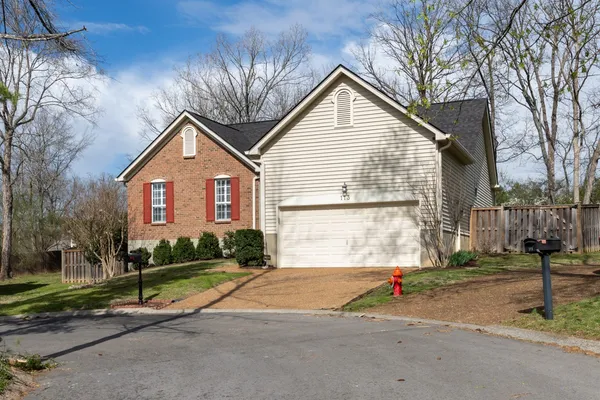 a view of a house with a yard and plants