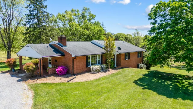 a living room with fireplace furniture and a chandelier