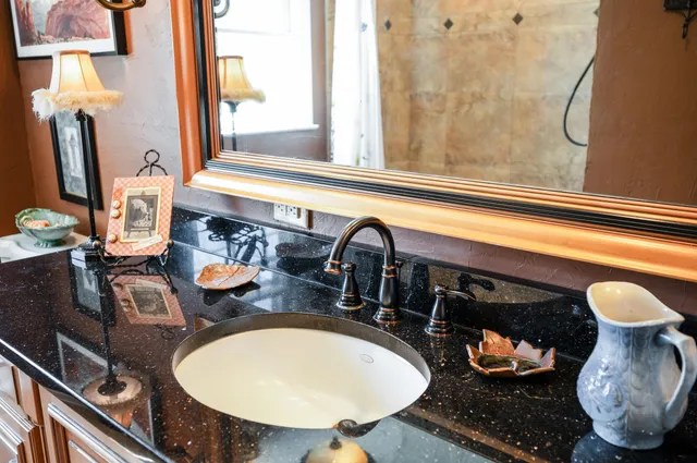 a bathroom with a sink mirror vanity and toilet