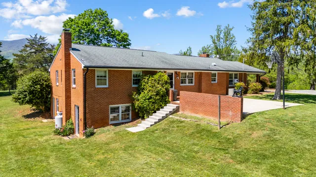 a view of a dining room with furniture water view and backyard of the house