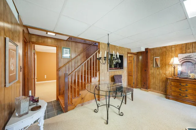 a view of house with yard and sitting area