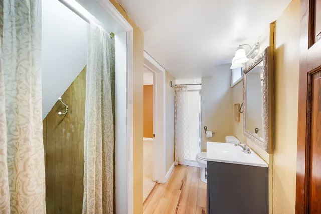 a view of a lush green hillside and a houses