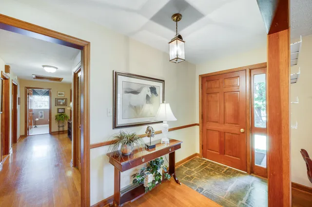 a view of an empty room with a mountain from a window