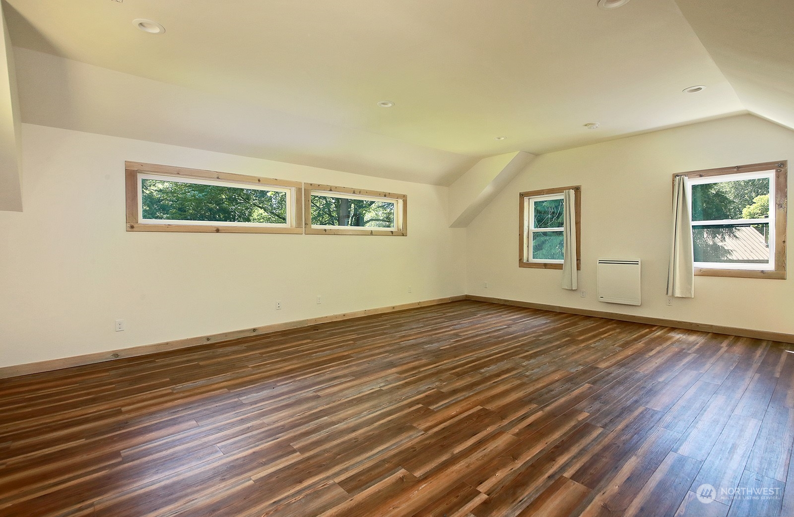 5368 Mapleglen Road Langley, WA 98260 - Photo 22 of 40 a view of an empty room with wooden floor and a window