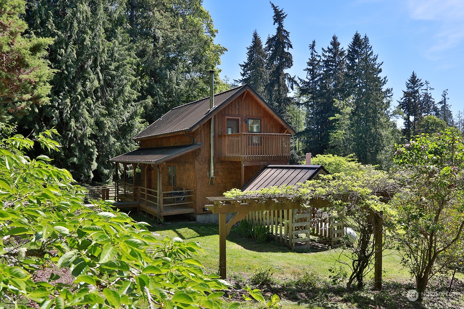 5368 Mapleglen Road Langley, WA 98260 - Photo 27 of 40 a view of a house with a yard and potted plants