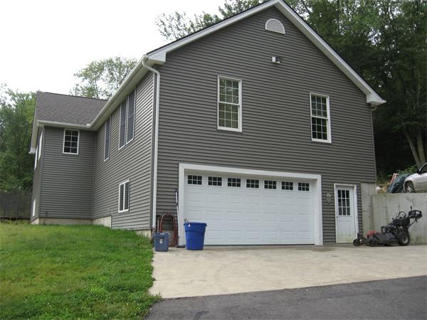 53 Bunyan Road Monson, MA 01057 - Photo 3 of 30 a view of a house with a yard and garage