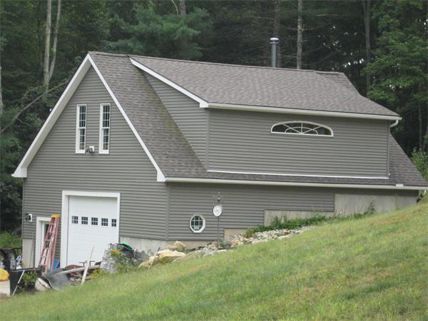 53 Bunyan Road Monson, MA 01057 - Photo 5 of 30 a front view of house with yard and trees in the background