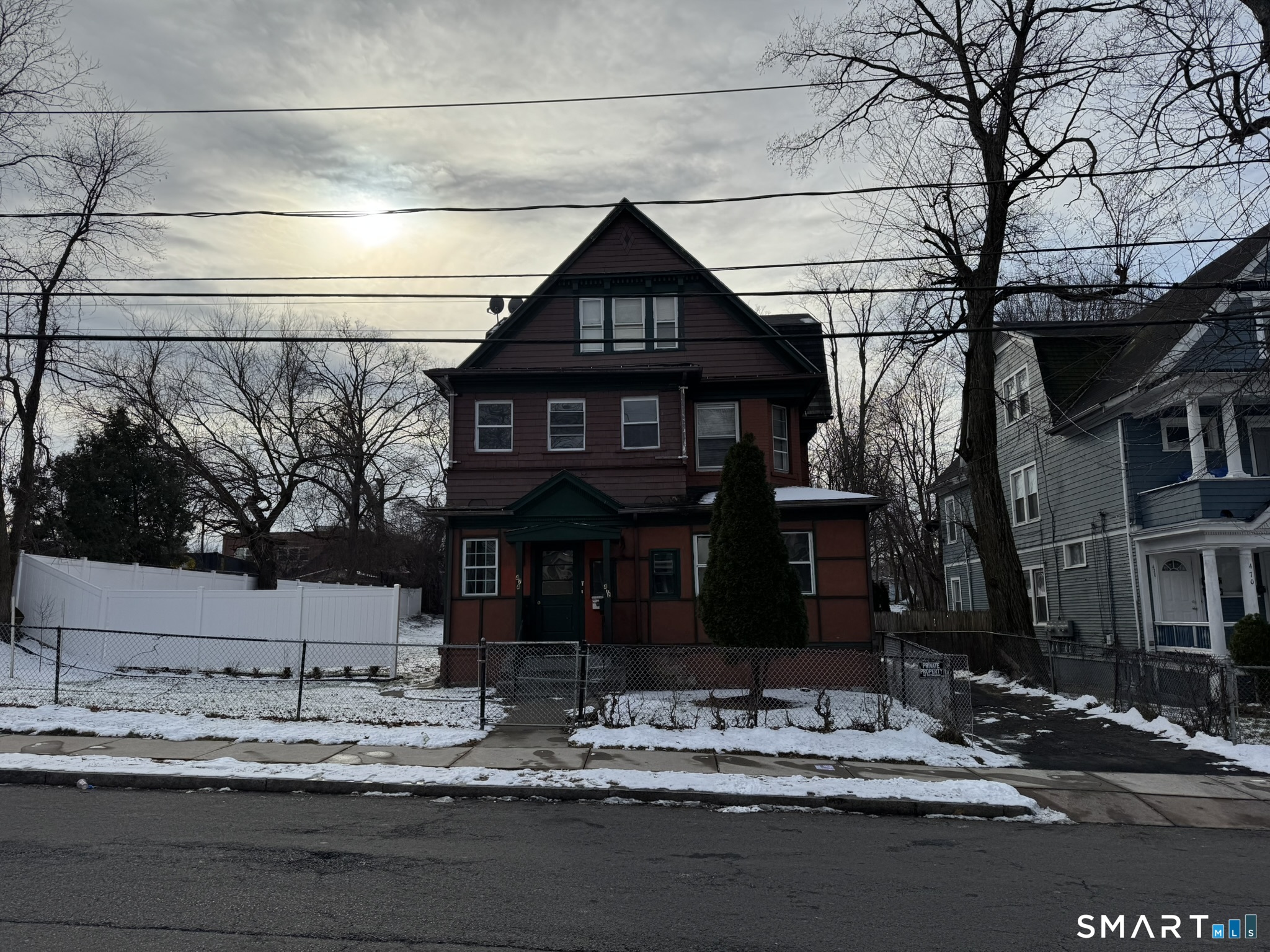 a front view of a house with trees