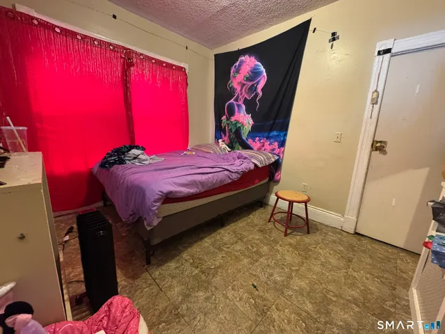 a bed room with a bed and a chair