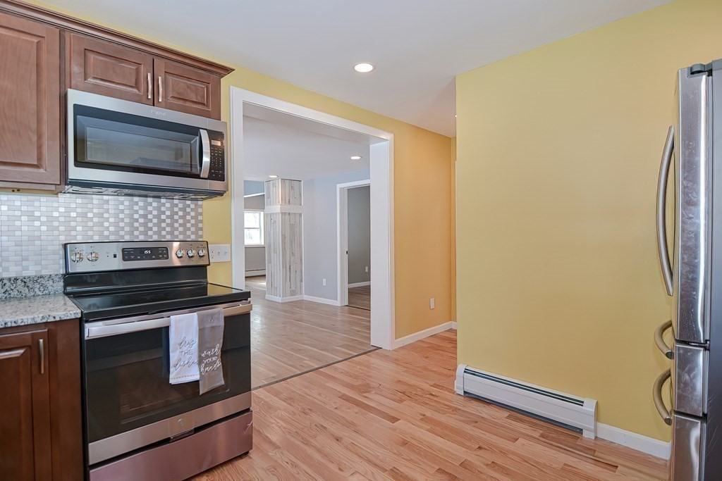 21 Groton Road Shirley, MA 01464 - Photo 5 of 27 a kitchen with stainless steel appliances a stove microwave and a refrigerator