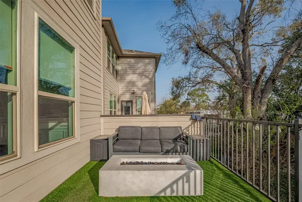 a view of a house with a wooden fence