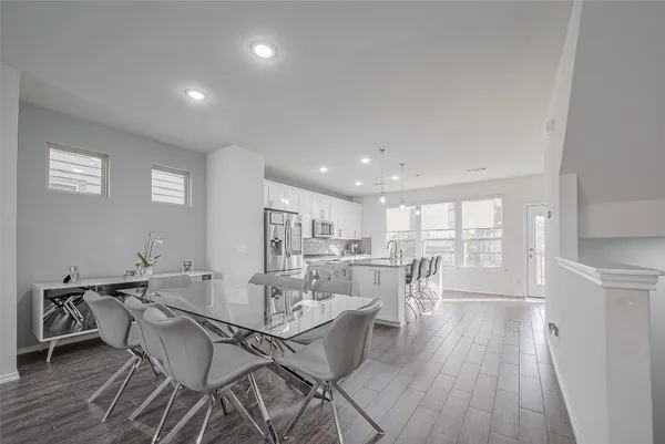 a view of a dining room with furniture and wooden floor
