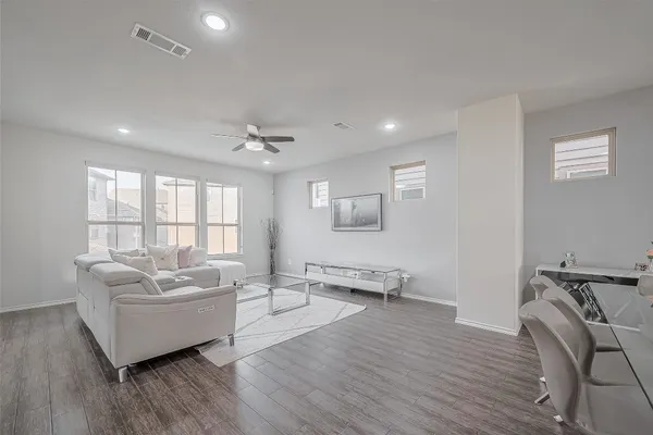 a living room with furniture window and wooden floor