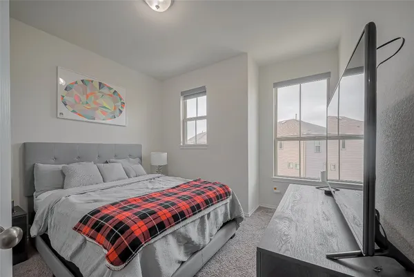 a bedroom with a bed and a window