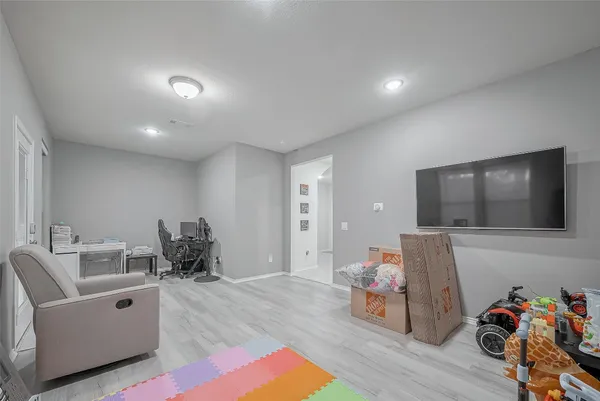a bed room with furniture and a flat screen tv