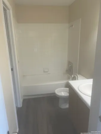 a bathroom with a toilet a sink and bathtub
