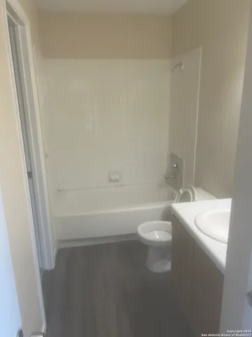 a bathroom with a toilet a sink and bathtub