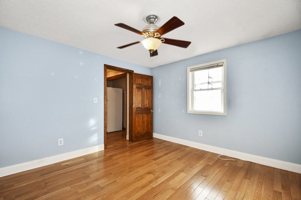 164 Ayer Road, Unit H4 Shirley, MA 01464 - Photo 12 of 33 an empty room with ceiling fan and window