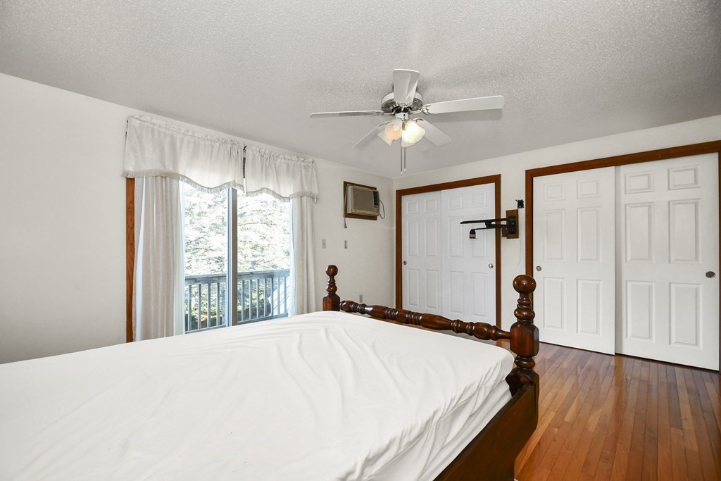 164 Ayer Road, Unit H4 Shirley, MA 01464 - Photo 21 of 33 a bedroom with a large bed and a window