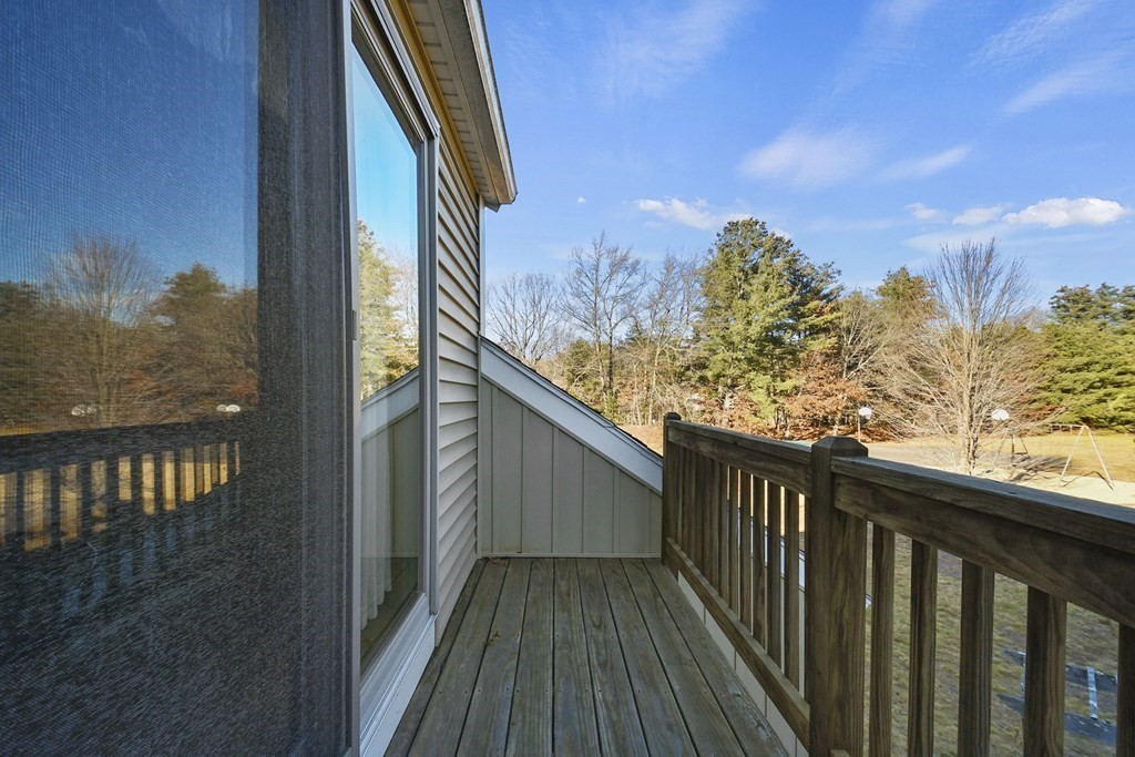 164 Ayer Road, Unit H4 Shirley, MA 01464 - Photo 23 of 33 a view of a balcony with wooden floor and fence