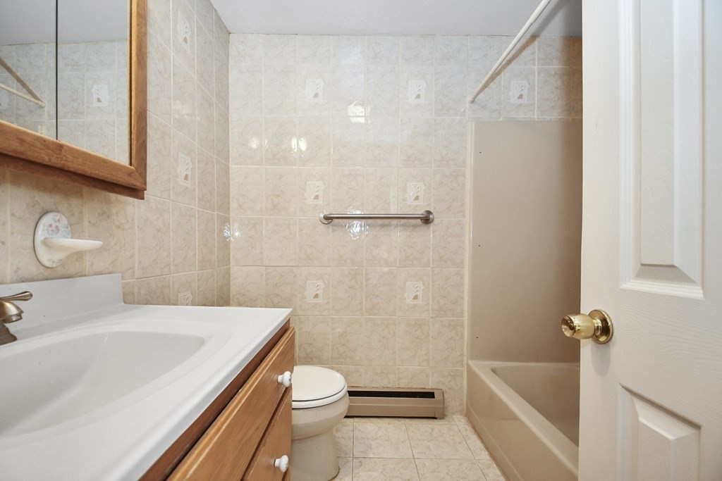 164 Ayer Road, Unit H4 Shirley, MA 01464 - Photo 24 of 33 a bathroom with a sink a toilet and shower