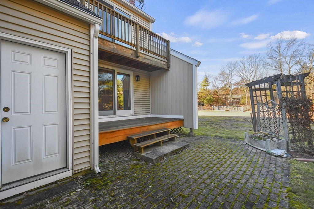 164 Ayer Road, Unit H4 Shirley, MA 01464 - Photo 27 of 33 a backyard of a house with barbeque oven table and chairs