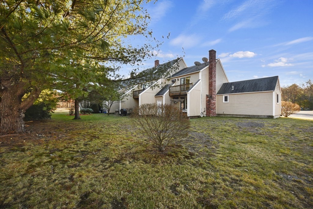 164 Ayer Road, Unit H4 Shirley, MA 01464 - Photo 32 of 33 a view of a house with a yard
