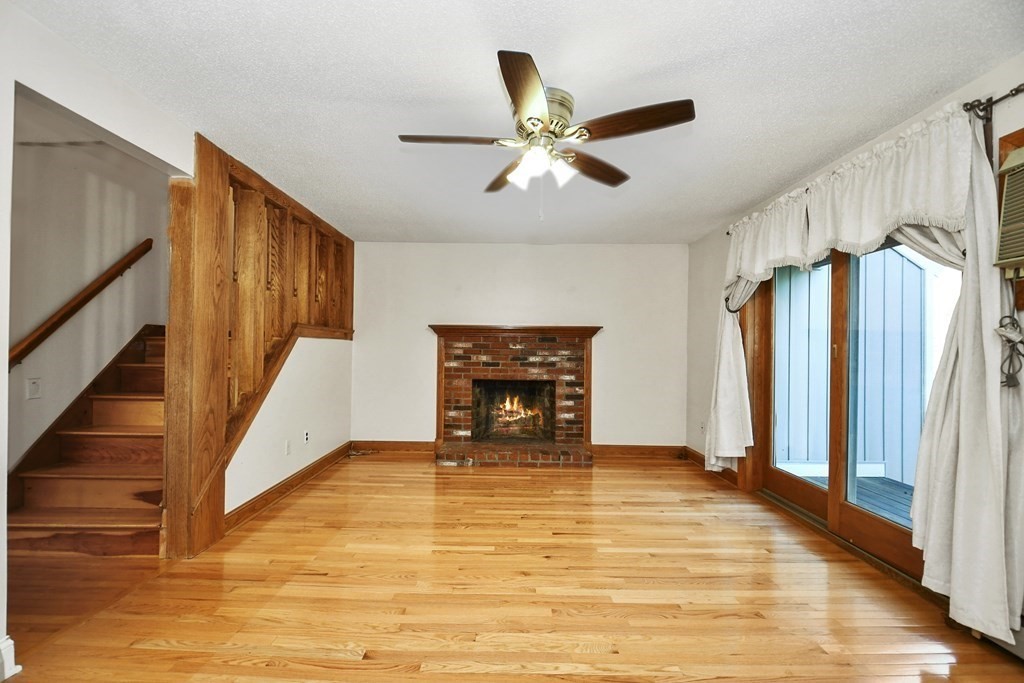 164 Ayer Road, Unit H4 Shirley, MA 01464 - Photo 4 of 33 a view of an empty room with wooden floor and a window