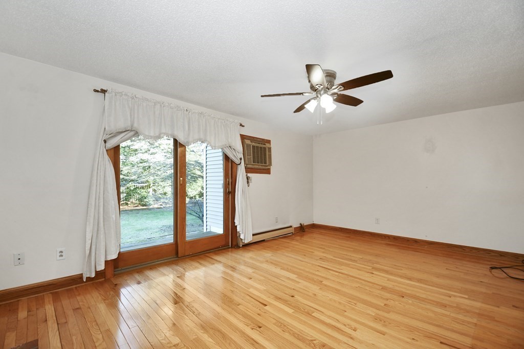 164 Ayer Road, Unit H4 Shirley, MA 01464 - Photo 6 of 33 wooden floor in an empty room with a window
