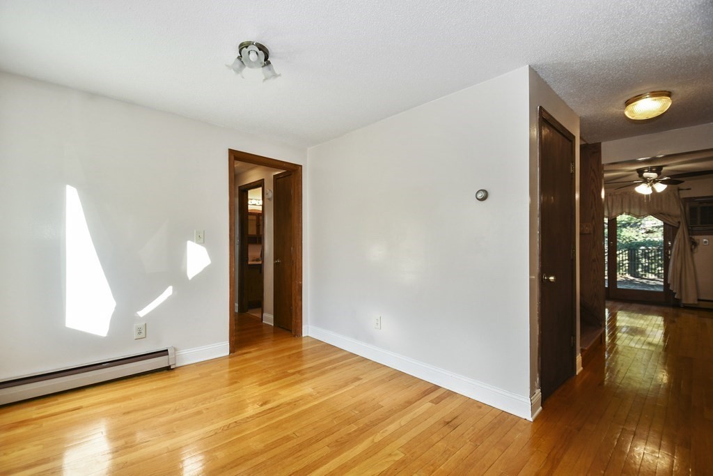 164 Ayer Road, Unit H4 Shirley, MA 01464 - Photo 7 of 33 a view of a room with wooden floor and a window