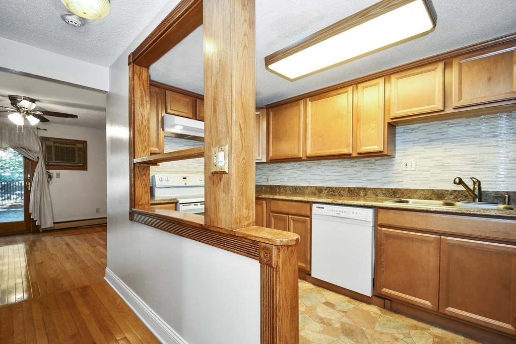 164 Ayer Road, Unit H4 Shirley, MA 01464 - Photo 8 of 33 a kitchen with stainless steel appliances granite countertop a stove a sink and a microwave