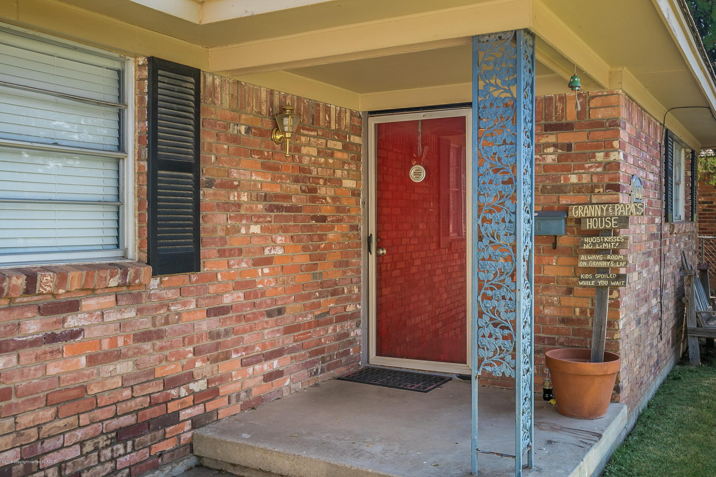 6016 Elmhurst Road Amarillo, TX 79106 - Photo 2 of 21 a front view of a house with a red gate