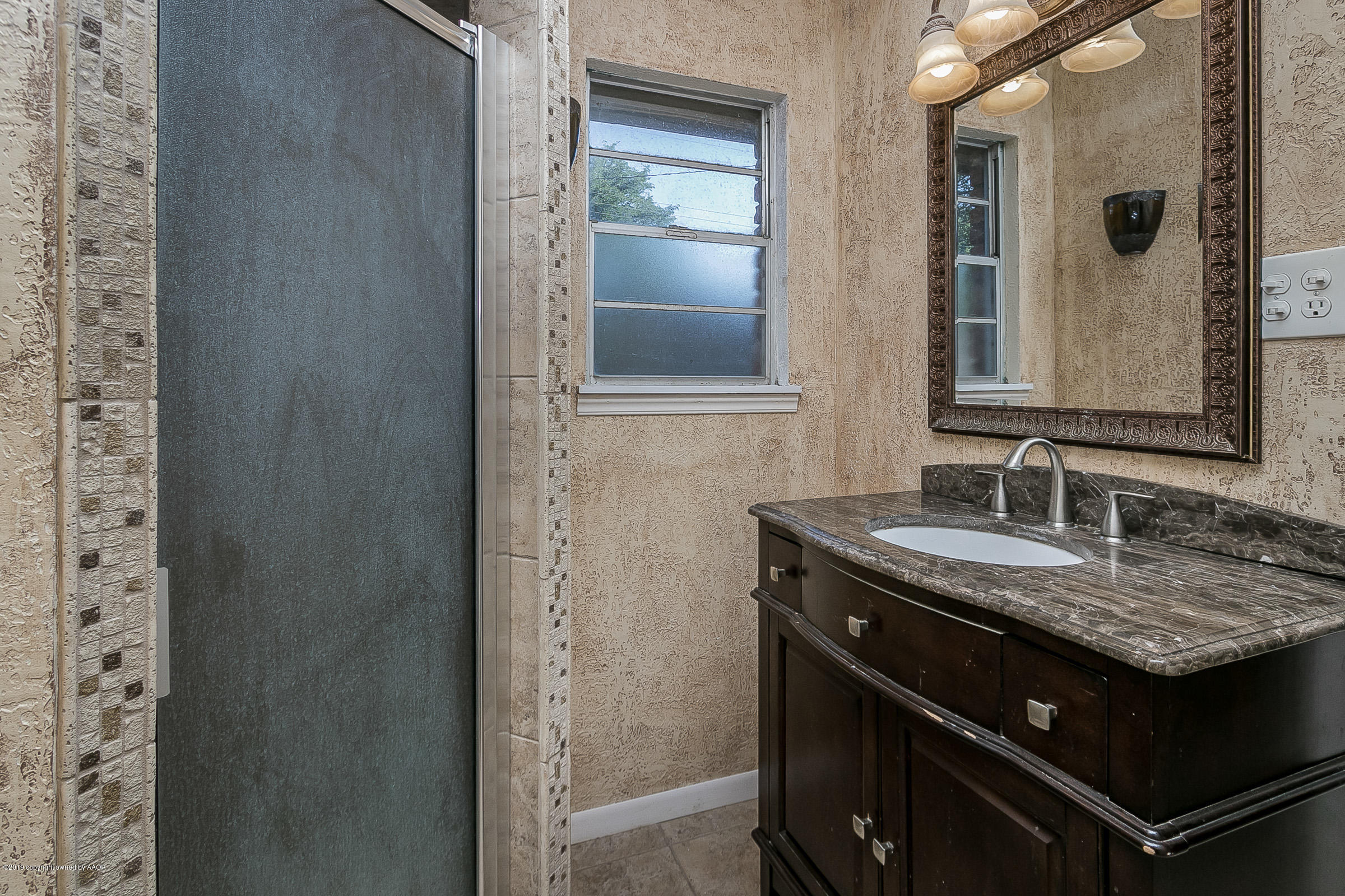 6016 Elmhurst Road Amarillo, TX 79106 - Photo 13 of 21 a sink and a mirror