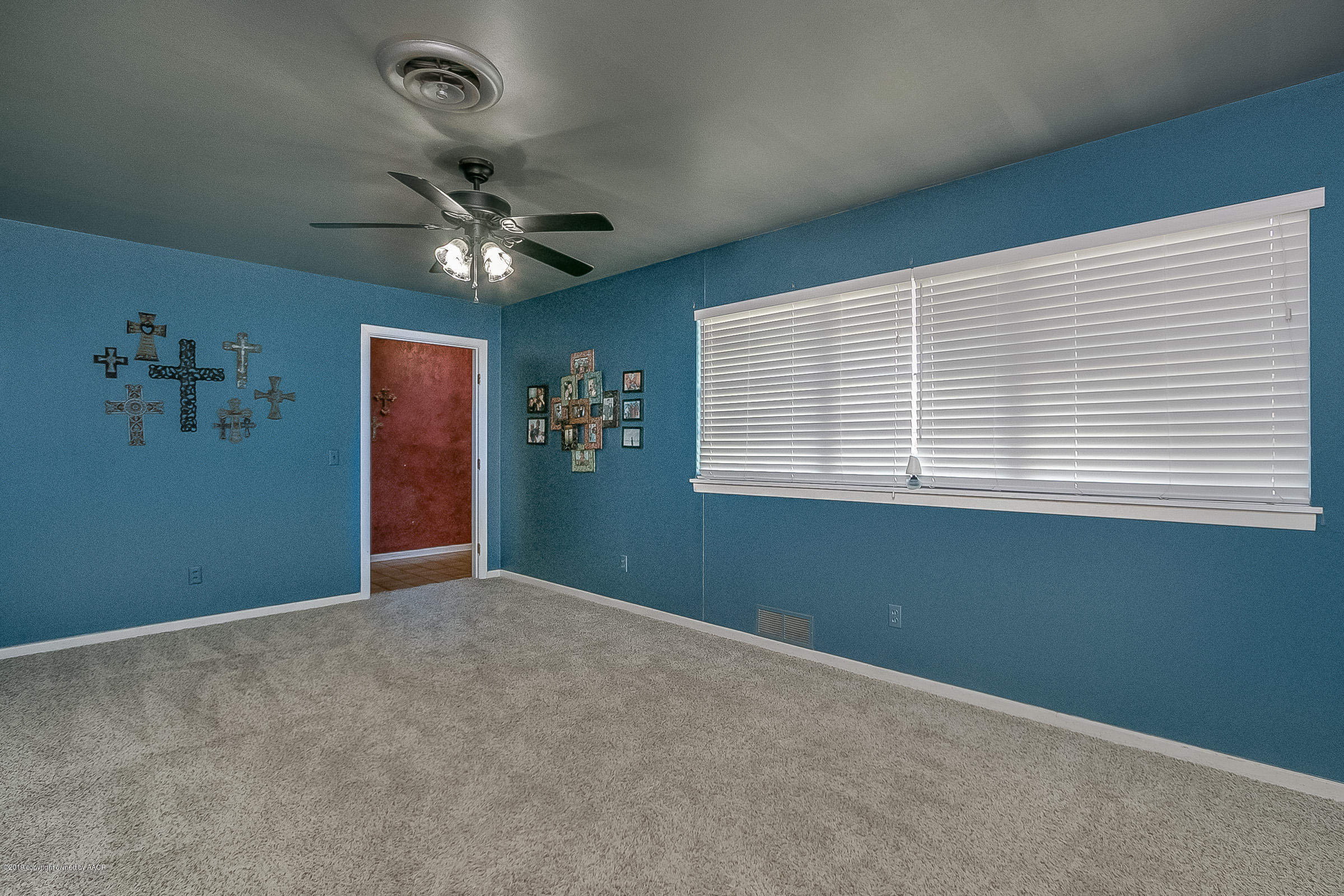 6016 Elmhurst Road Amarillo, TX 79106 - Photo 4 of 21 an empty room with windows and fan