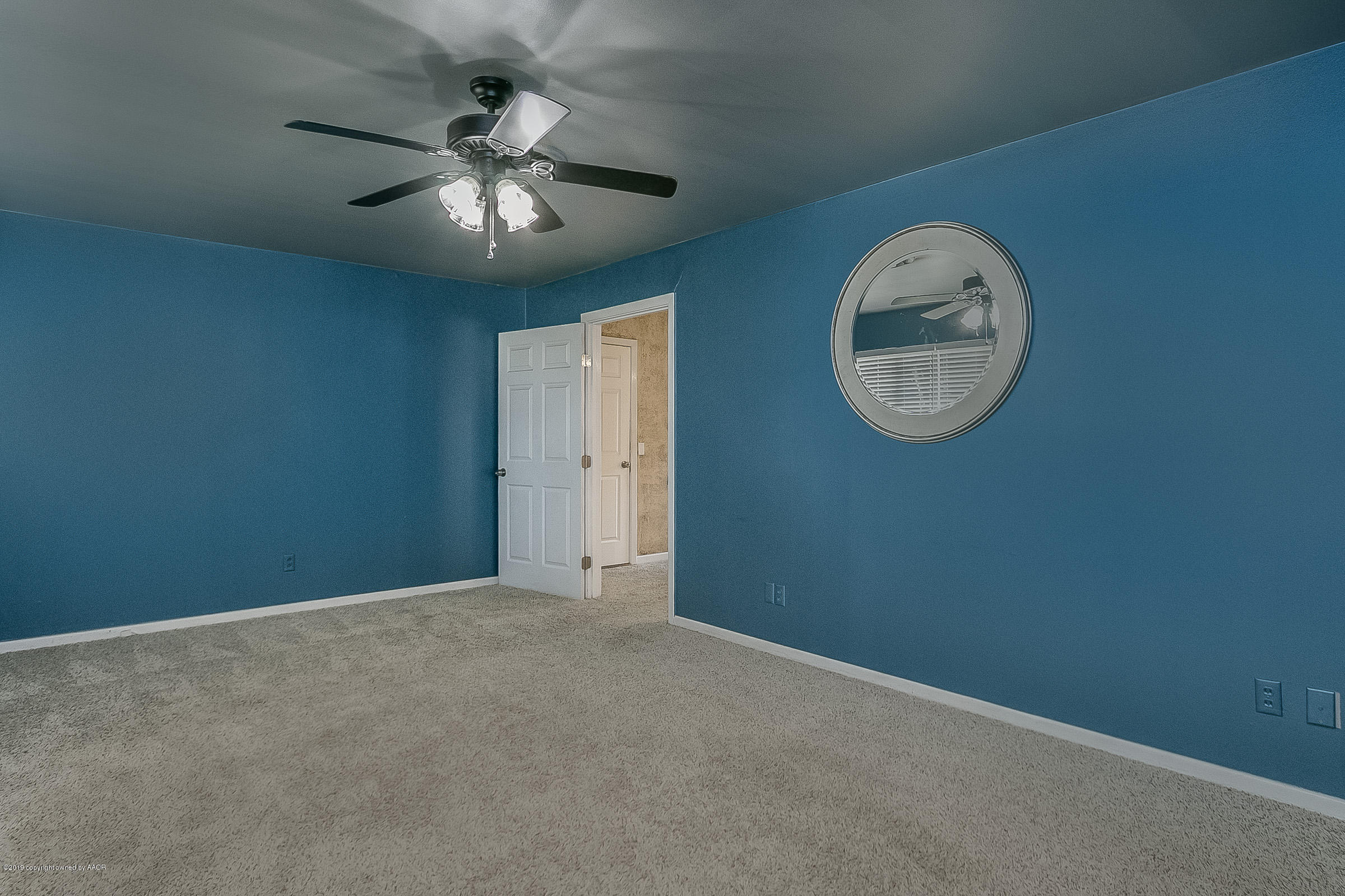 6016 Elmhurst Road Amarillo, TX 79106 - Photo 5 of 21 an empty room with a chandelier fan