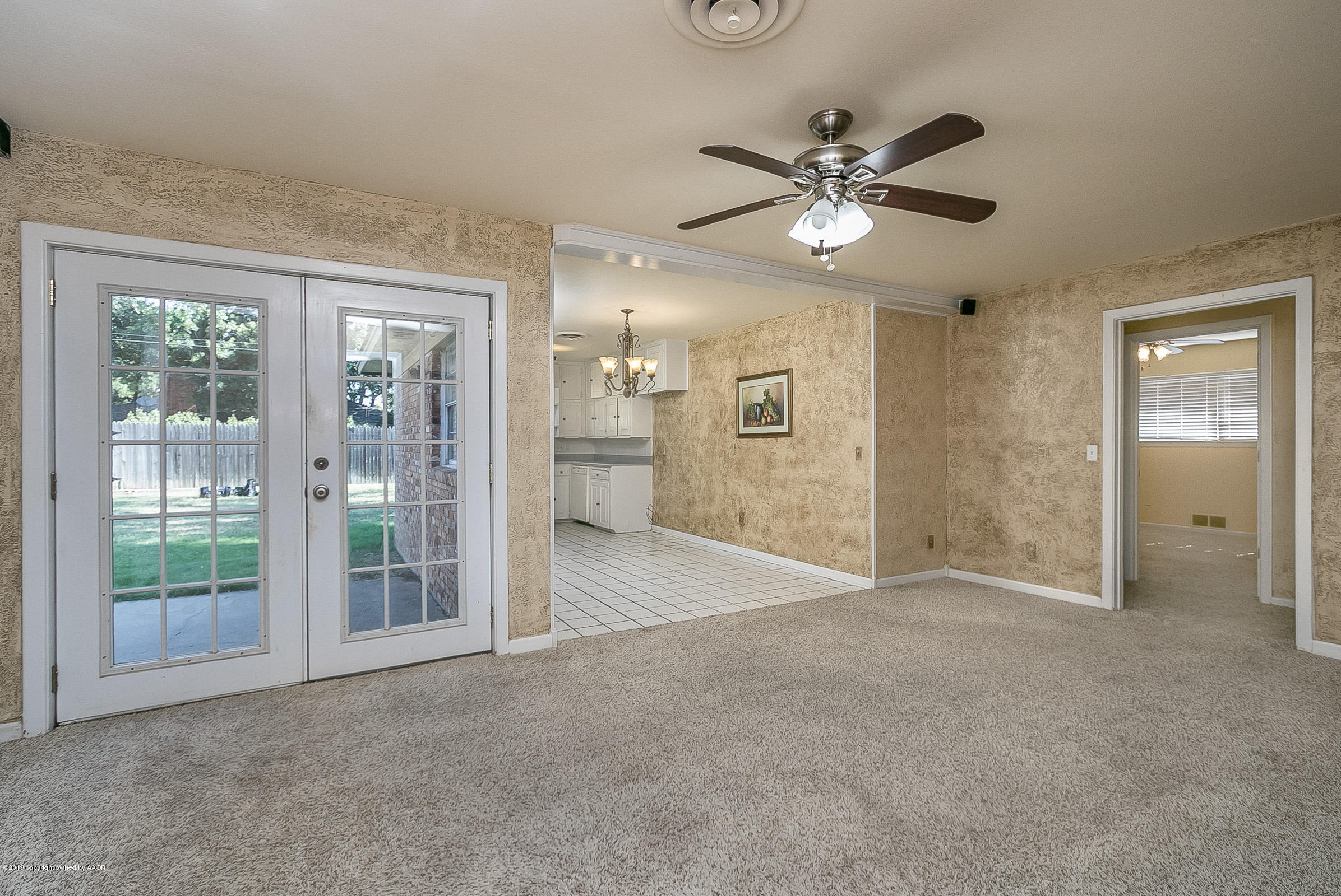 6016 Elmhurst Road Amarillo, TX 79106 - Photo 6 of 21 a view of a livingroom with a ceiling fan and window