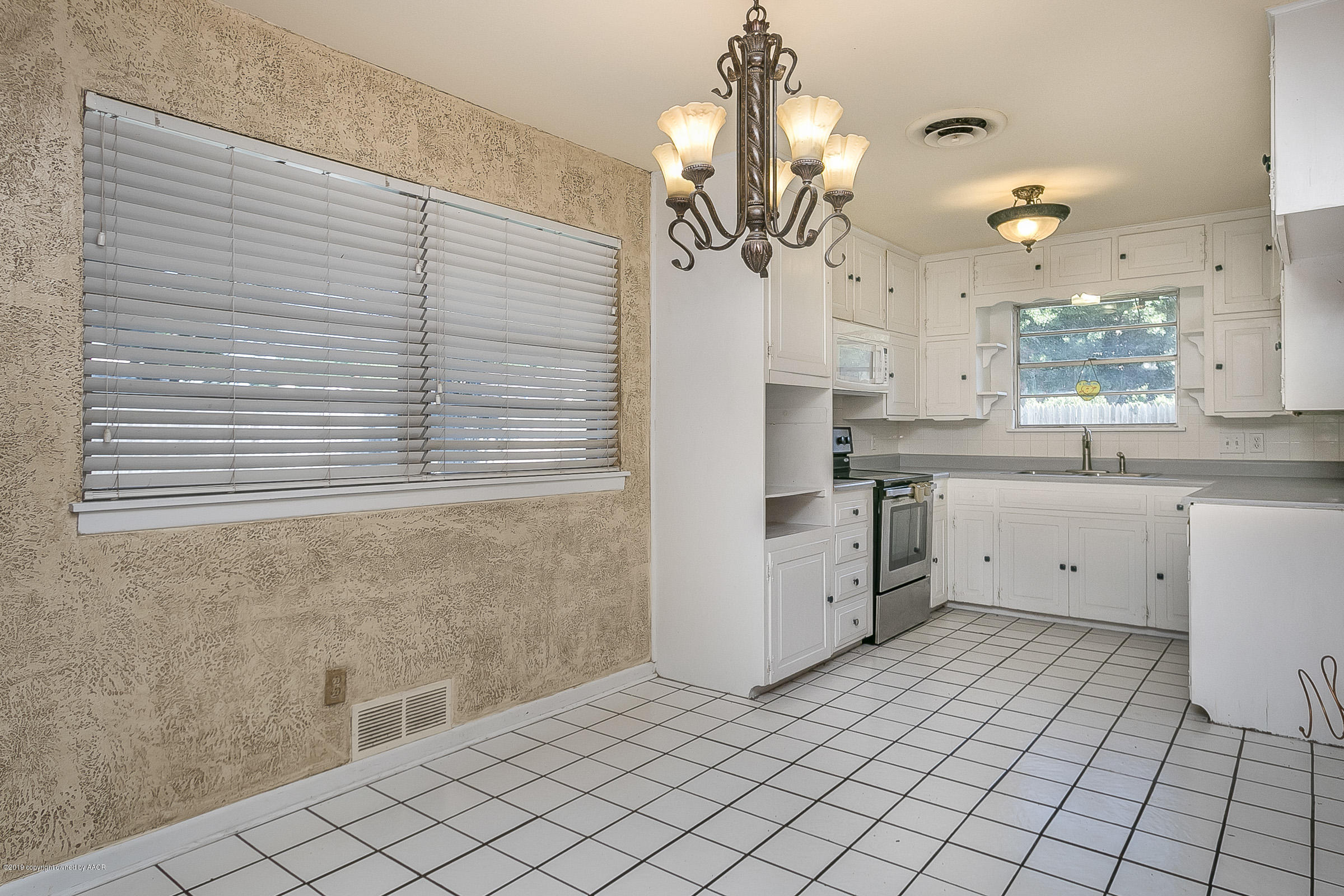 6016 Elmhurst Road Amarillo, TX 79106 - Photo 8 of 21 a view of a kitchen with a sink and chandelier