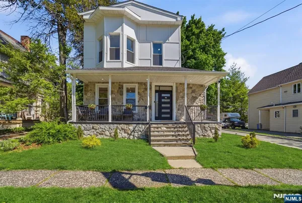 a front view of a house with a yard table and chairs