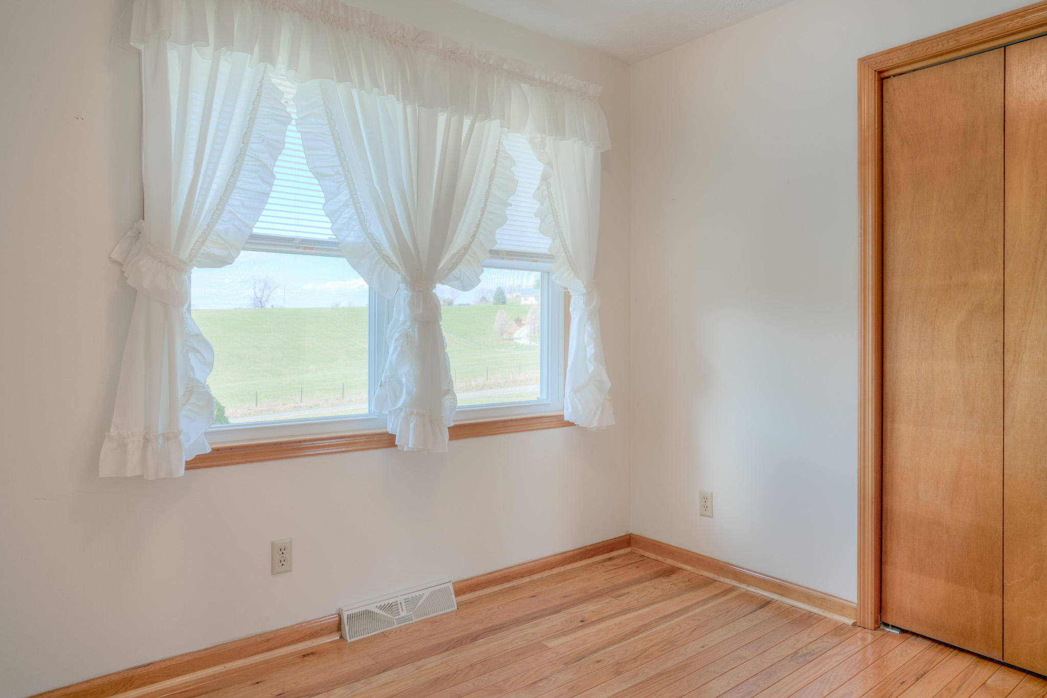 4964 Lizzie Gunn Road Pulaski, VA 24301 - Photo 12 of 31 a view of an empty room with wooden floor and a window