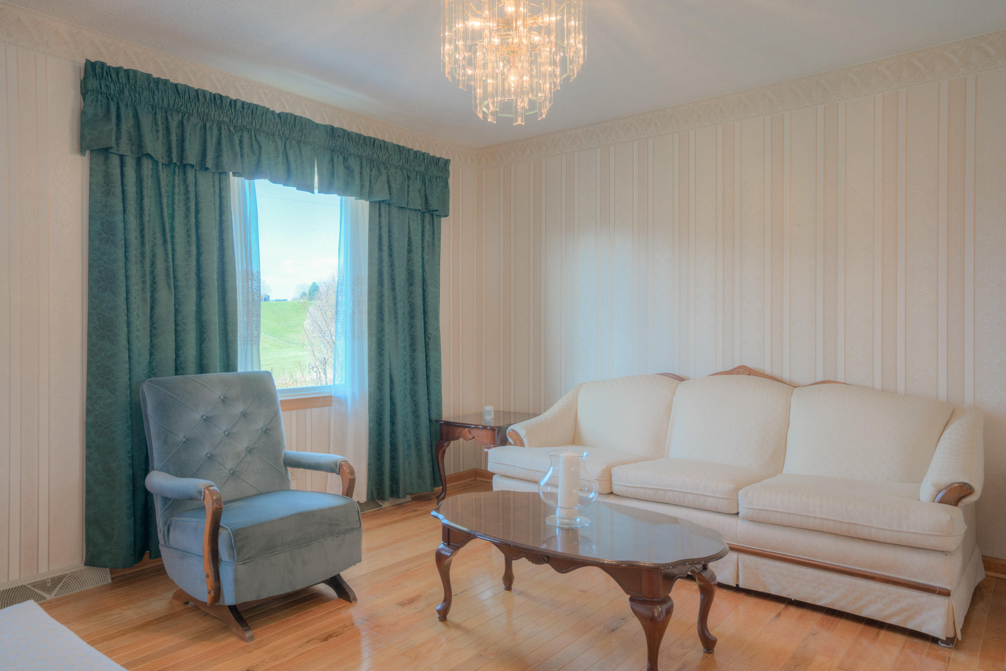 4964 Lizzie Gunn Road Pulaski, VA 24301 - Photo 5 of 31 a living room with furniture and a chandelier