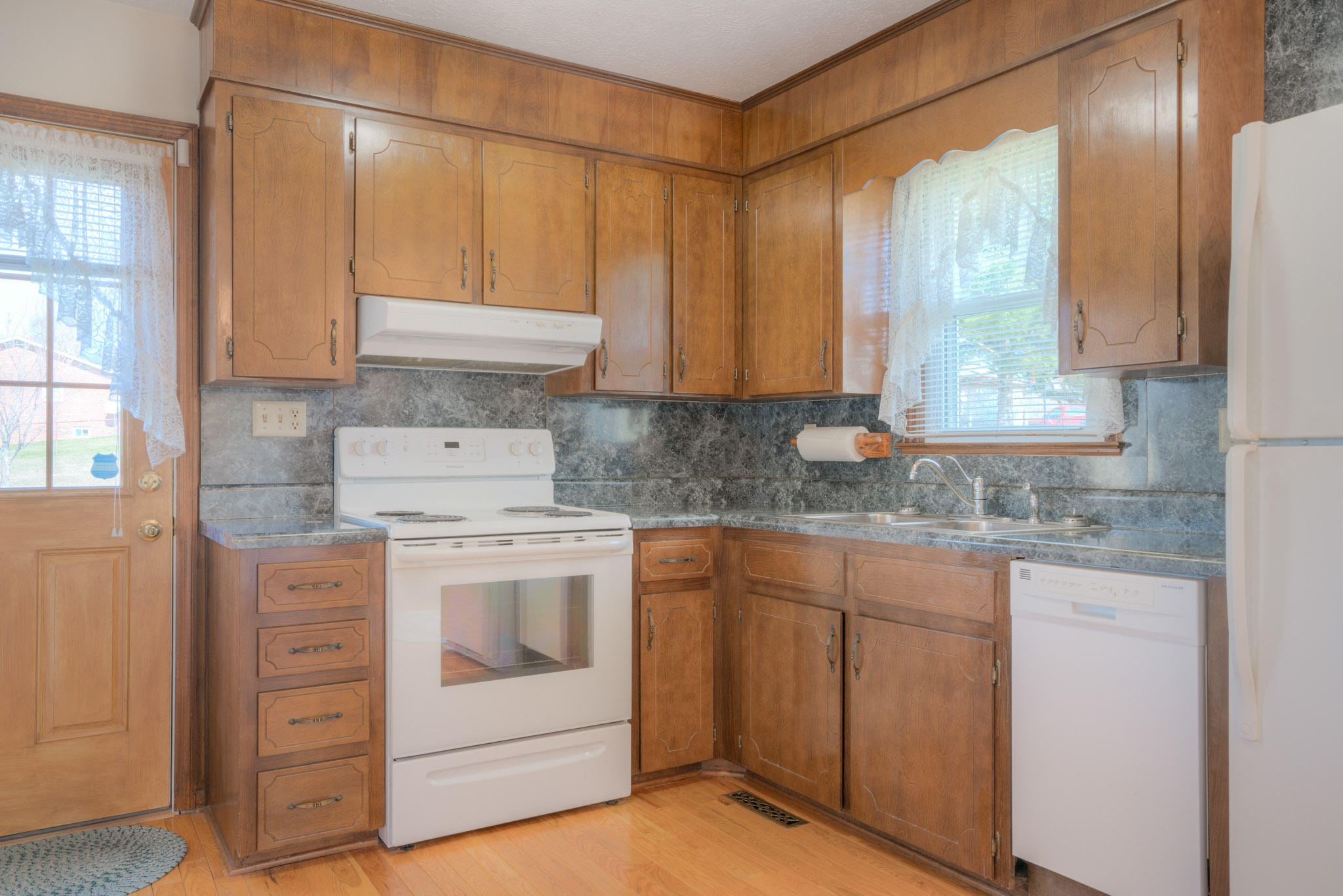 4964 Lizzie Gunn Road Pulaski, VA 24301 - Photo 9 of 31 a kitchen with white cabinets and white appliances