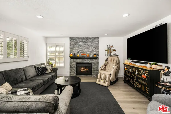 a kitchen with stainless steel appliances kitchen island granite countertop a stove a refrigerator a stove a dining table and chairs