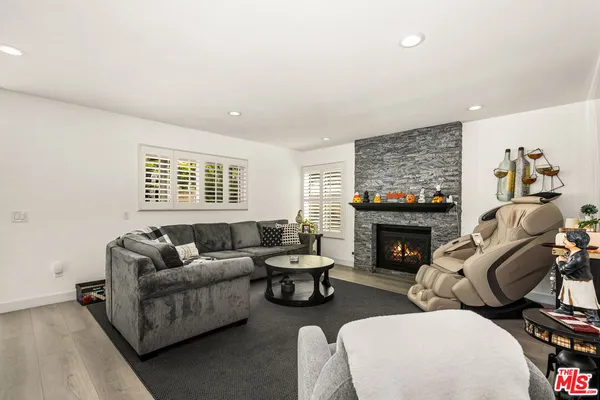 a kitchen with stainless steel appliances a stove and wooden floor