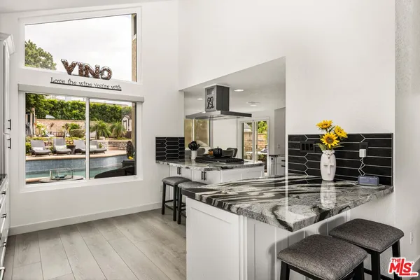 a large bathroom with a granite countertop sink a toilet a mirror and shower