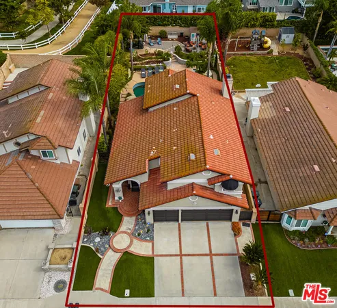 an aerial view of residential building with green space