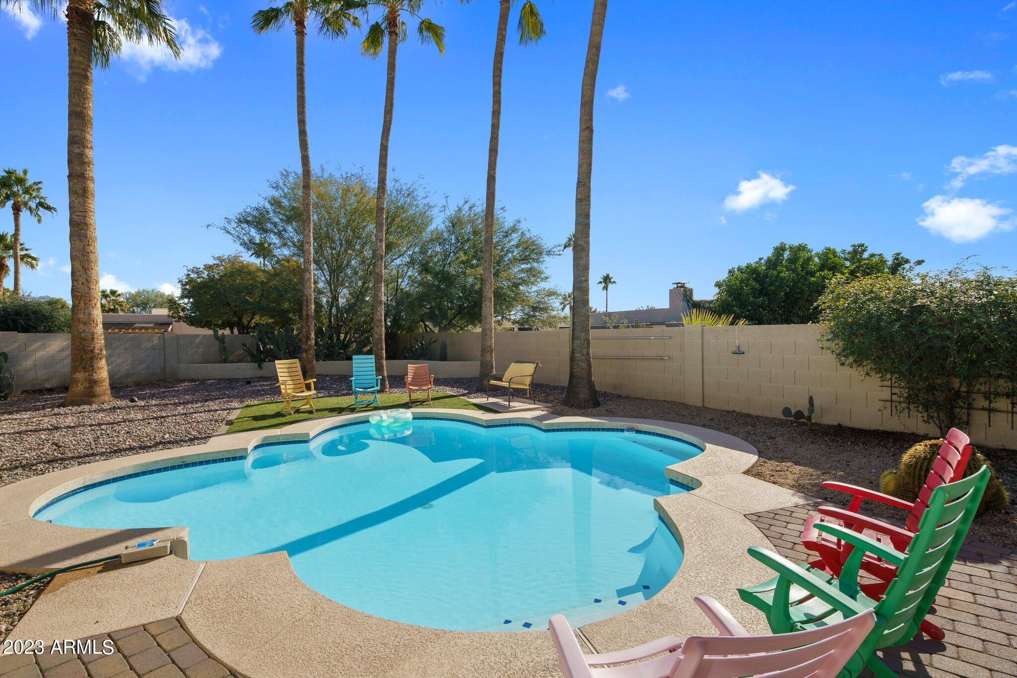 6609 East Phelps Road Scottsdale, AZ 85254 - Photo 1 of 83 a view of a swimming pool with a lounge chairs