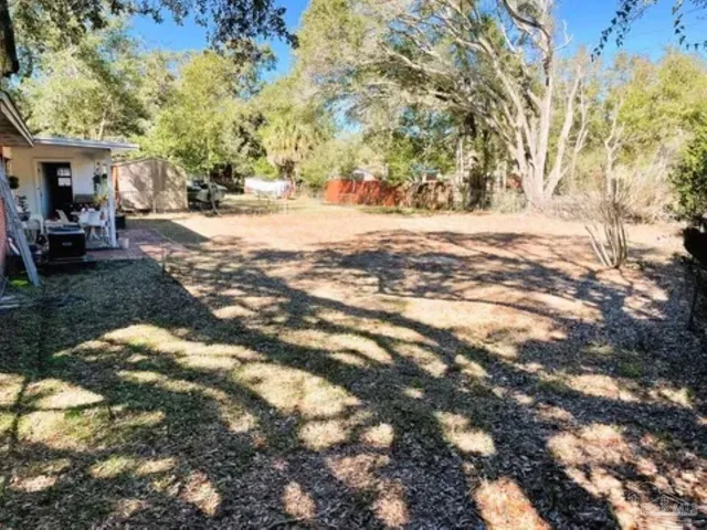 a view of open space with yard