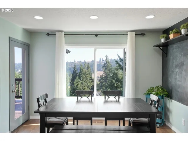 a view of a room with a table and chairs