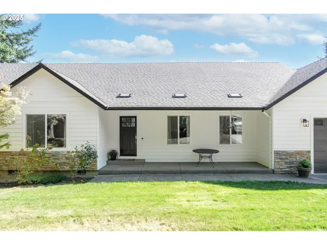 a view of a house with swimming pool and sitting area