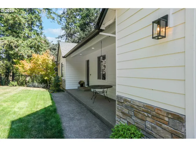 a backyard of a house with table and chairs